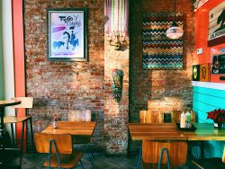 Photo by Katlyn Giberson on Unsplash / colorful coffee shop with brick wall / WLOY